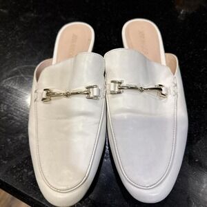 White leather mules with silver buckle detail